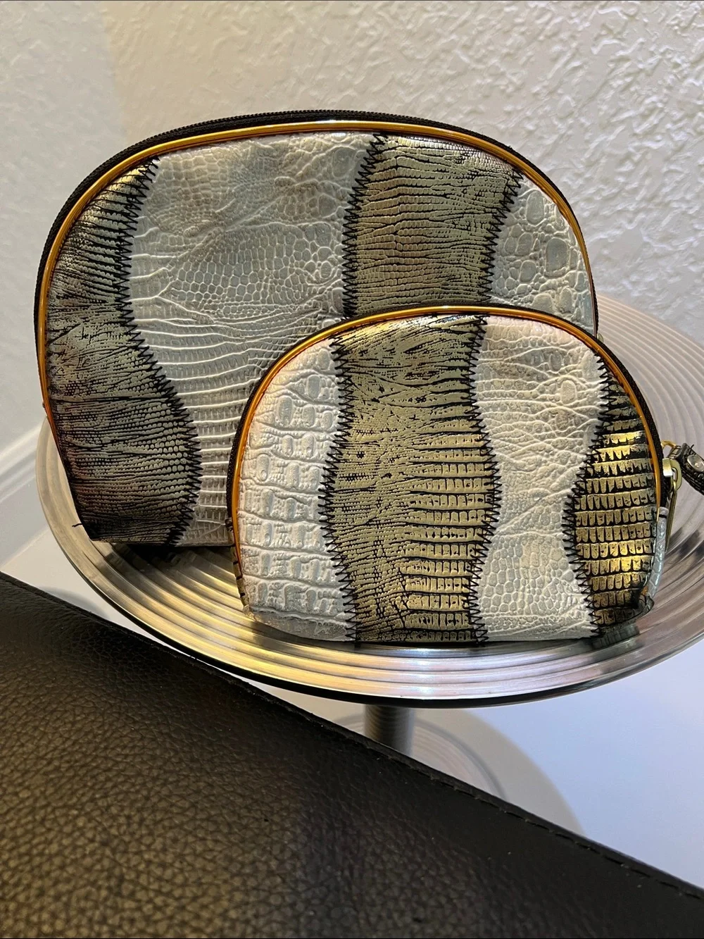 A DUO GOLD and SILVER DECORATIVE POUCH SET.